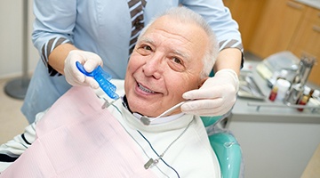 A happy senior man receiving dental care