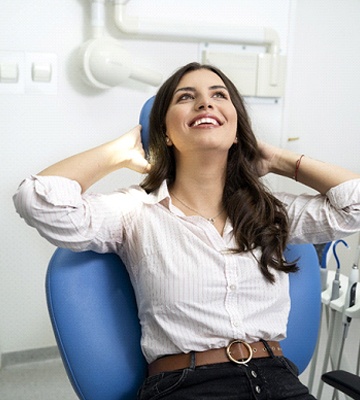 Woman in dental chair relaxing after learning about cost of sedation
