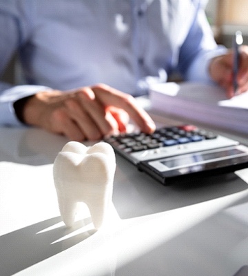 man calculating cost of Teeth in a Day