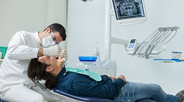 Dentist placing restorations for dental implants in Colleyville