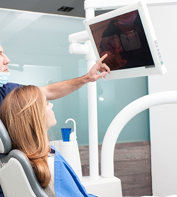 Dentist showing patient dental x-rays
