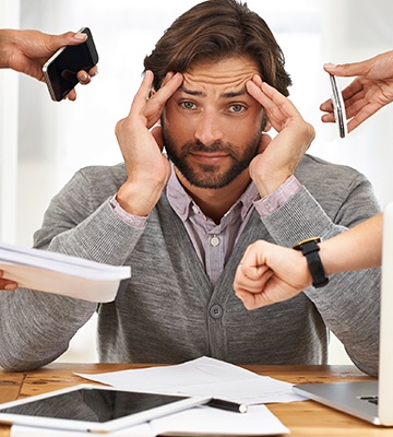 Man in pain holding his head