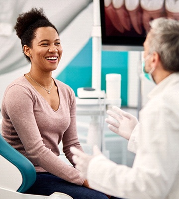 woman talking to cosmetic dentist in Colleyville