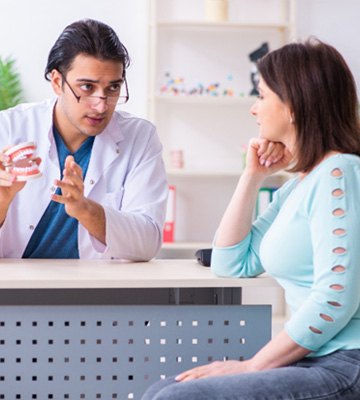 Patient listening to dentist in Colleyville talk about tooth extraction 