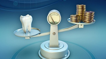 Tooth and coins on balance scale