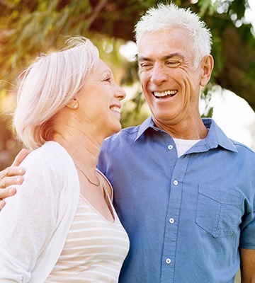 Smiling older man and woman outdoors