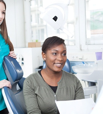 Dentist explaining cost of dental implants in Colleyville to patient