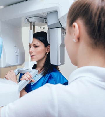 Patient standing in CBCT machine, ready for scanning process