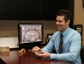 dentist showing patient x rays in Colleyville