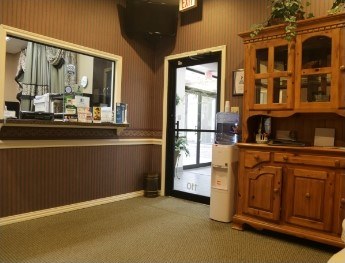 patient smiling at receptionist in Colleyville