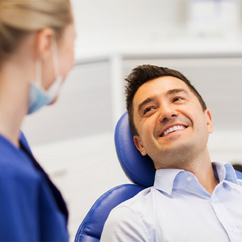 Man smiling after completing dental treatment