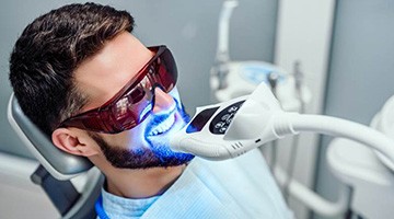 Man undergoing in-office teeth whitening in Colleyville, TX