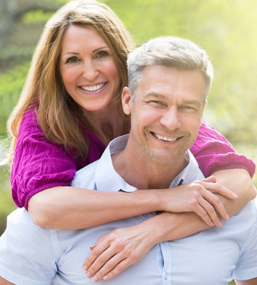 Smiling older man and woman outdoors