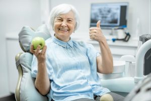 older woman smiling in dentist chair