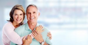 an older couple hugging and smiling