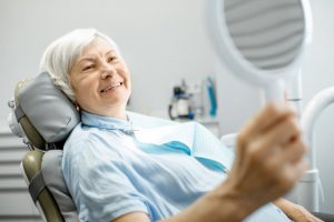 Woman checking teeth and smiling