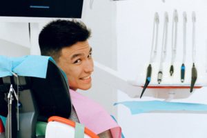 Man smiling during dental checkup.