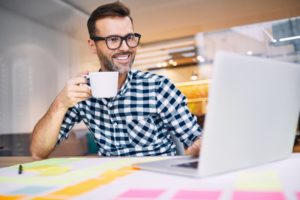 smiling man drinking coffee