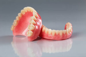 Upper and lower denture on gray background