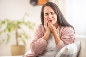a patient dealing with intense tooth pain