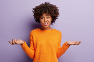 Woman shrugging and looking confused