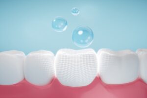 Fluoride bubbles floating above teeth in animated rendering.